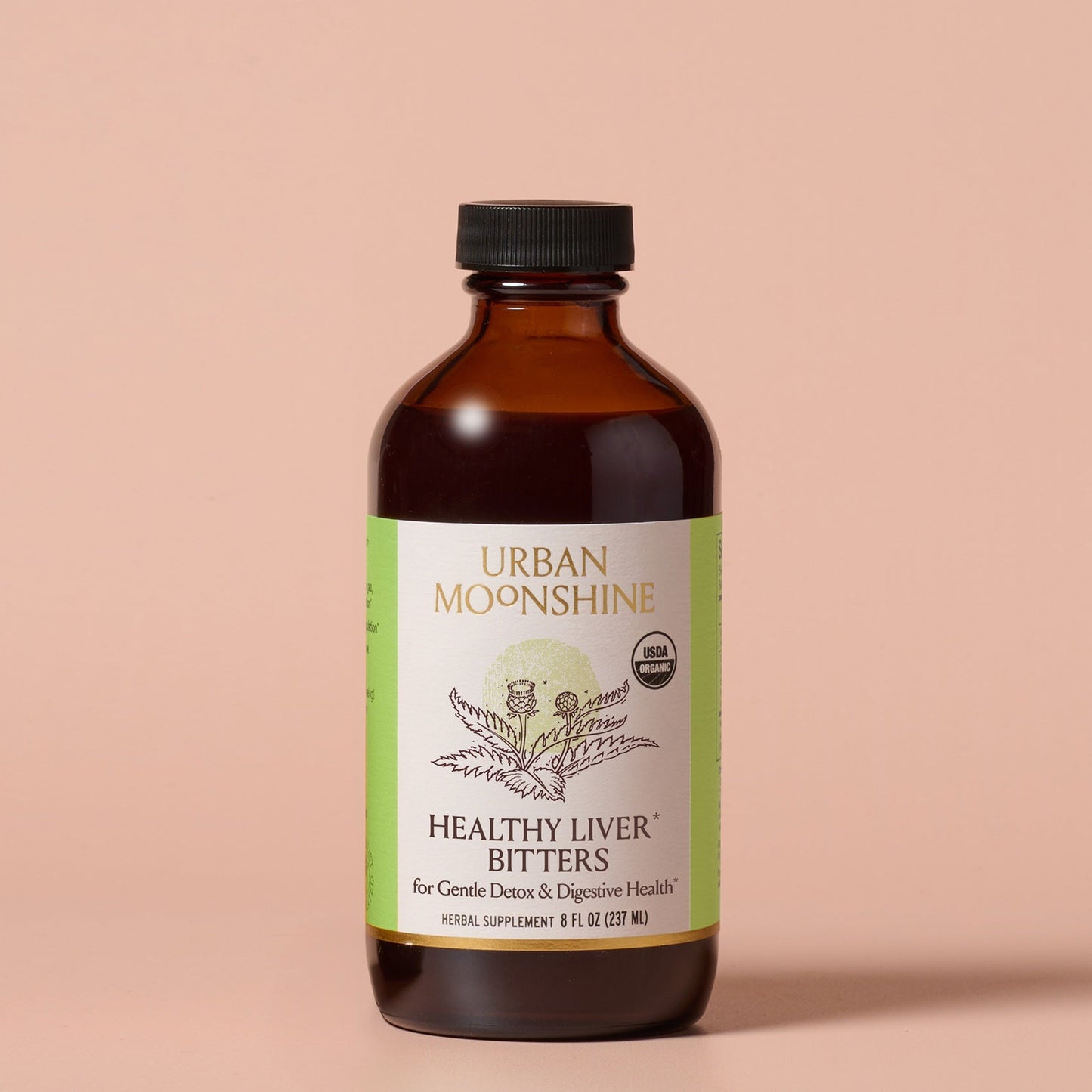 Bottle of Urban Moonshine Healthy Liver Bitters on a beige background