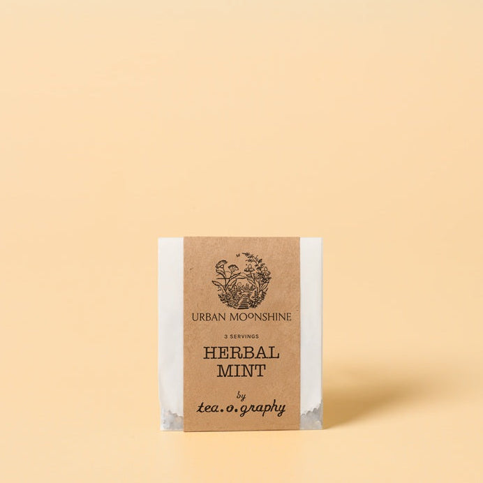 Tea package with 'Urban Moonshine' branding on a beige background